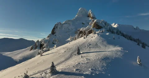 Fly over and around the mountains of Ciucas Romania in January 2022 Sunny day. Stock Footage 170200531