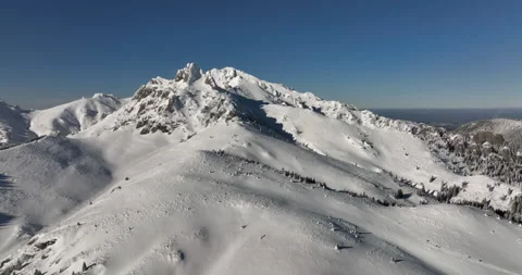 Fly over and around the mountains of Ciucas Romania in January 2022 Sunny day. Stock Footage 170200611