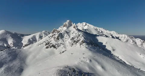 Fly over and around the mountains of Ciucas Romania in January 2022 Sunny day. Stock Footage 170201133
