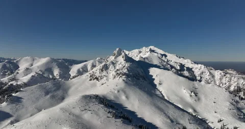 Fly over and around the mountains of Ciucas Romania in January 2022 Sunny day. Stock Footage 170201237