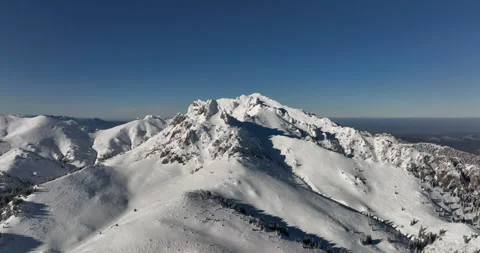 Fly over and around the mountains of Ciucas Romania in January 2022 Sunny day. Stock Footage 170201605
