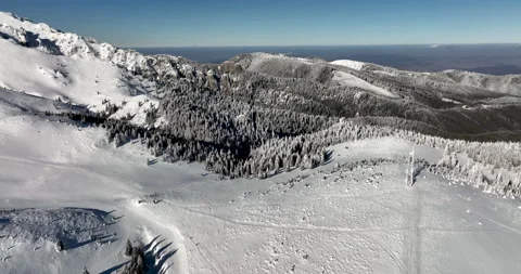 Fly over and around the mountains of Ciucas Romania in January 2022 Sunny day. Stock Footage 170201963