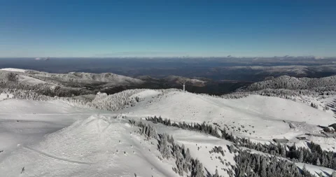 Fly over and around the mountains of Ciucas Romania in January 2022 Sunny day. Stock Footage 170202000
