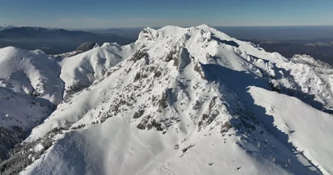 Fly over and around the mountains of Ciucas Romania in January 2022 Sunny day. Stock Footage 170202048