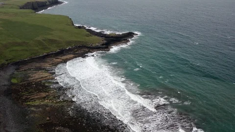Fly over a beach with waves crushing on Isle of Skye to end up over the ocean 스톡 동영상 116049035