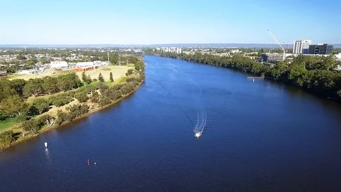 Fly over boat on river panning to cityscape Stock Footage 100363689