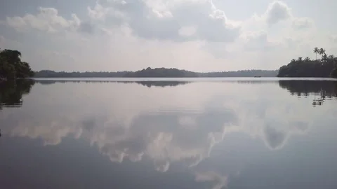 Fly over the calm lake view of sailboat at sunrise drone footage Stock Footage 84982262