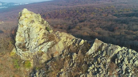 Fly over cliff and mountainous terrain with forest views Stock Footage 152999051