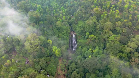 Fly over clouds and discover a waterfall Stock Footage 340969440
