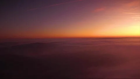 Fly over Clouds and mountains break through in the sunrise Stock Footage 143535395