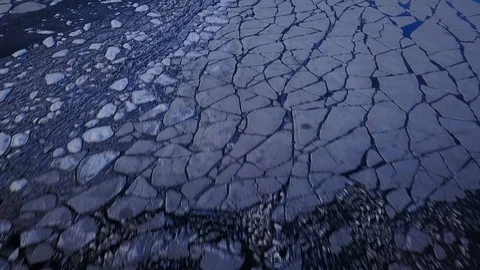 Fly over cracked ice with sunset light Stock Footage 94134653