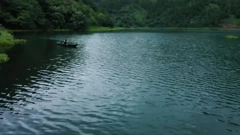 Fly over the dark lake water past the fishermen Stock Footage 213928013