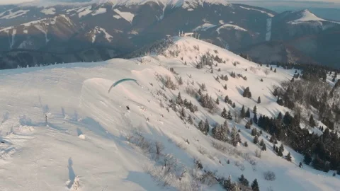 Fly Over Drone Shot Of Tandem Paraglide Over Snow Covered Mountains During 스톡 동영상 149201360