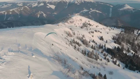 Fly Over Drone Shot Of Tandem Paraglide Over Snow Covered Mountains During Vídeo Stock 149201405