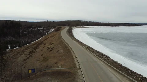Fly over edge of Brasseau Dam in winter Stock Footage 151783311