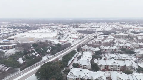 Fly over empty Dallas highway during Snow storm Stock Footage 261578243