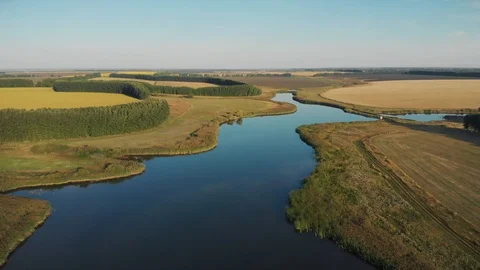 Fly over farm fields and pond Stock Footage 118160809