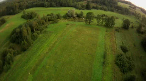 Fly over field fish eye view Stock Footage