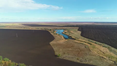 Fly over the fields to a small reservoir Stock Footage 153074426