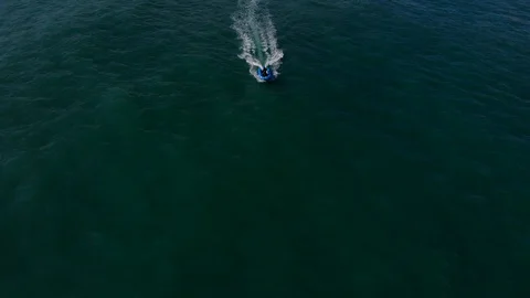 Fly over floating blue rubber boat in sea Stock Footage 105806029