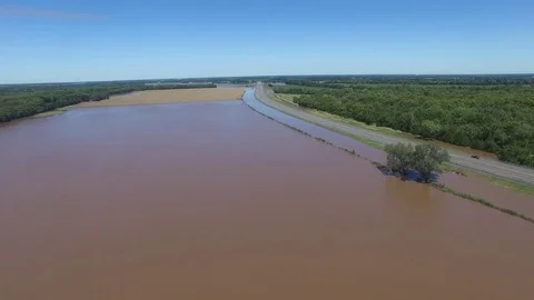 Fly over of flooded field with highway nearby Stock Footage 69912697