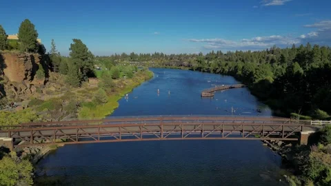 Fly Over Footbridge on River in Bend Oregon with Paddle Boarders. Stock Footage 249747627