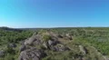 Fly over girl's hiker silhouette on mountain . Aerial view HD Footage