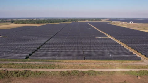Fly over hay field to large solar power panel Farm in Rural Texas Stock Footage 217241459