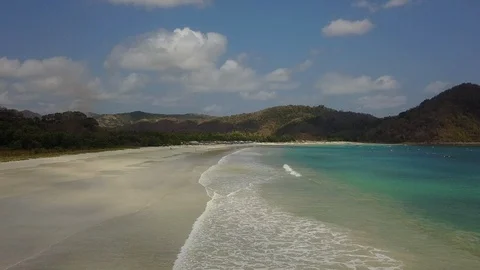 Fly over idyllic beach with turquoise and green water Stock Footage 129046177
