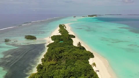Fly over Island in the ocean with trees and beach (Maldives) aerial shot 動画素材 252605117
