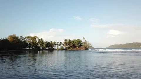 Fly over Island surrounded by ocean, Lines of Pure energy, waves power Stock Footage 99359722