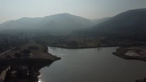 Fly over lake with mountain view morning drone shot in Khao Yai, thailand Stockbeeldmateriaal 148847224
