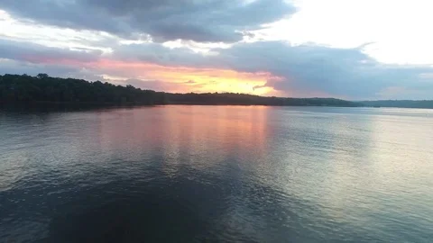 Fly over a lake at sunset Stock Footage 77697965