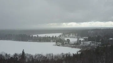 Fly over lake while it's snowing Stock-Footage 85589950