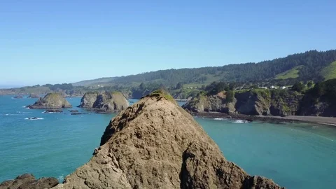 Fly over large island in Elk Cove on the Pacific Ocean Stock Footage 75876902