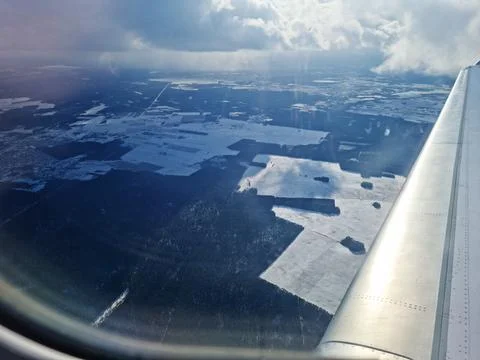 Fly over Lithuania in the early spring season snow and dark clouds around - view Stock Photos