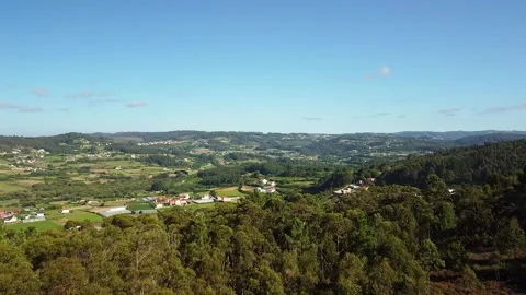Fly Over Lush Tree Forest Revealing Idyllic Rural Village. Aerial Drone Stock Footage 243299762