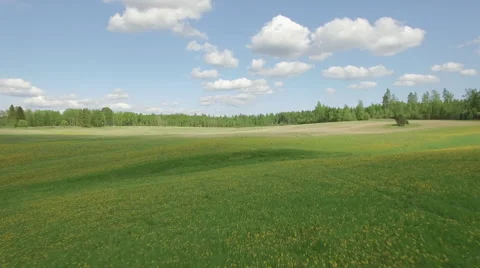 Fly over meadow view with nice clouds in Finland Video stock 64338452