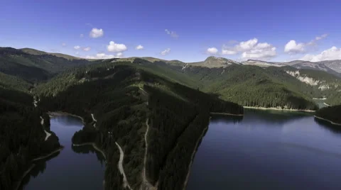Fly Over Mirror Mountain Lake Surrounded By Forest Stock-Footage 66418240