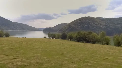 Fly Over Mountain Lake Surrounded By Forest Stock Footage 67604030