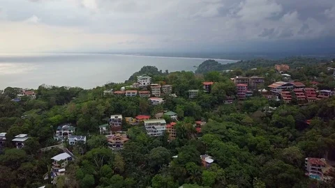 Fly Over Mountain Top Homes to Reveal Ocean Video stock 79447654