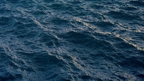 Fly over ocean water surface in evening time Stock Footage 80028899