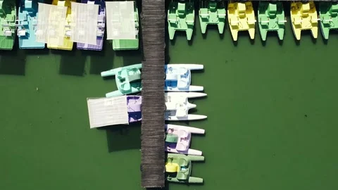 Fly over parked multicolored catamarans in a row at the pier Stock Footage 140986966