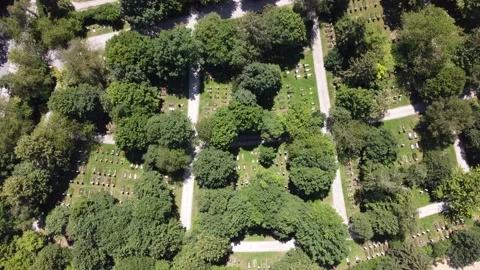 Fly over a public graveyard in Munich, Aubing during summer on a sunny day Stock Footage 201418725