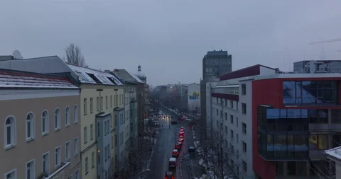Fly over queue of cars stopping at traffic lights on road intersection. Winter Stock Footage 166929378