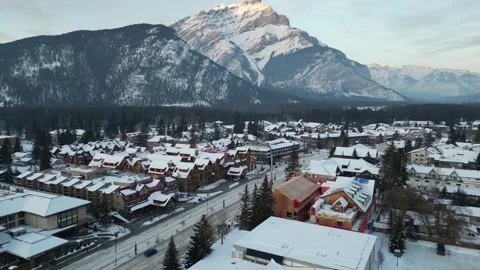 Fly over quiet ski town of Banff with Mount Norquay in the Background Stock Footage 241873324