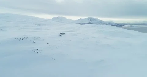 Fly over of remote snowy winter cabin in the arctic Stock Footage 152785460