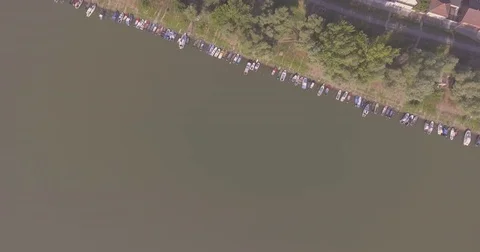 Fly over river bank and boats Video stock 80627933