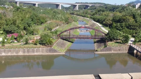 Fly over a river surrouned by trees and trails Stock Footage 101639764