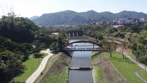 Fly over a river surrouned by trees and trails Video stock 101646416